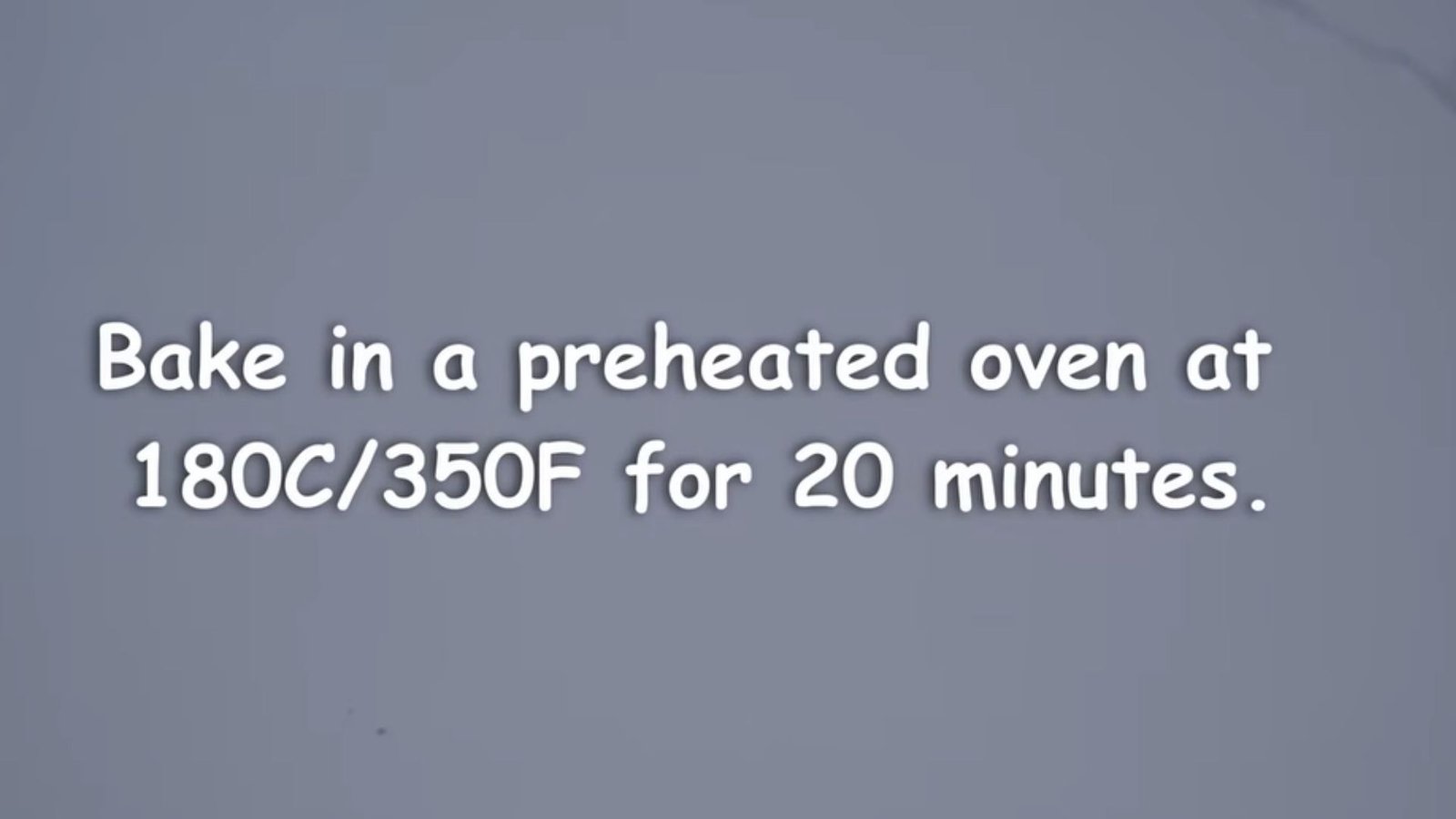 A grey slide with white text reading "Bake in a preheated oven at 180C/350F for 20 minutes."