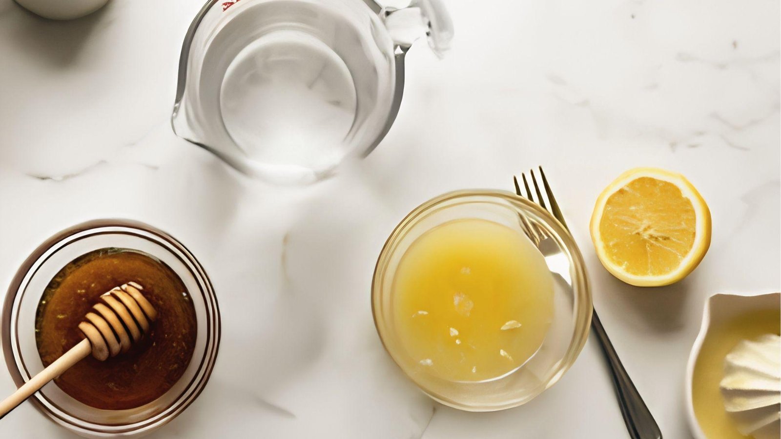 Top view of honey, lemon juice, and water ingredients prepped for honey trick recipe mix.