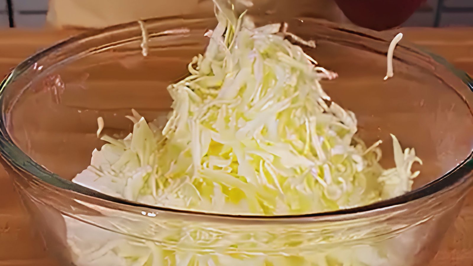 Grating cold butter into dry ingredients and tossing to create flaky ginger scone dough.