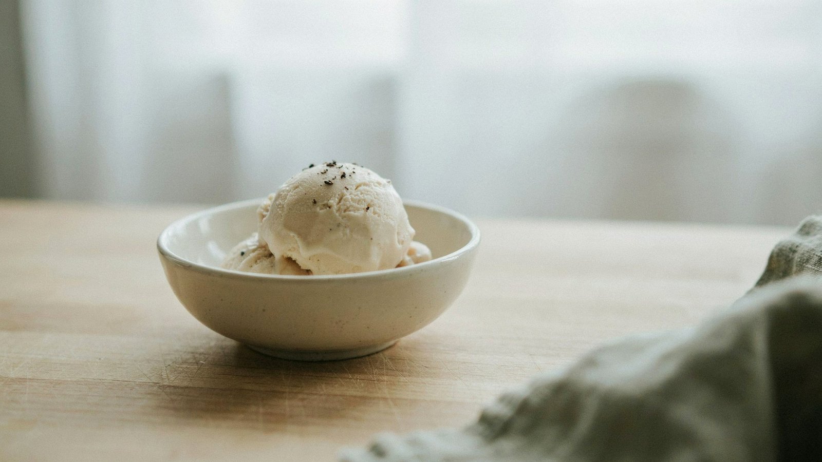 scoop of ice cream showing light airy texture and soft creamy appearance.
