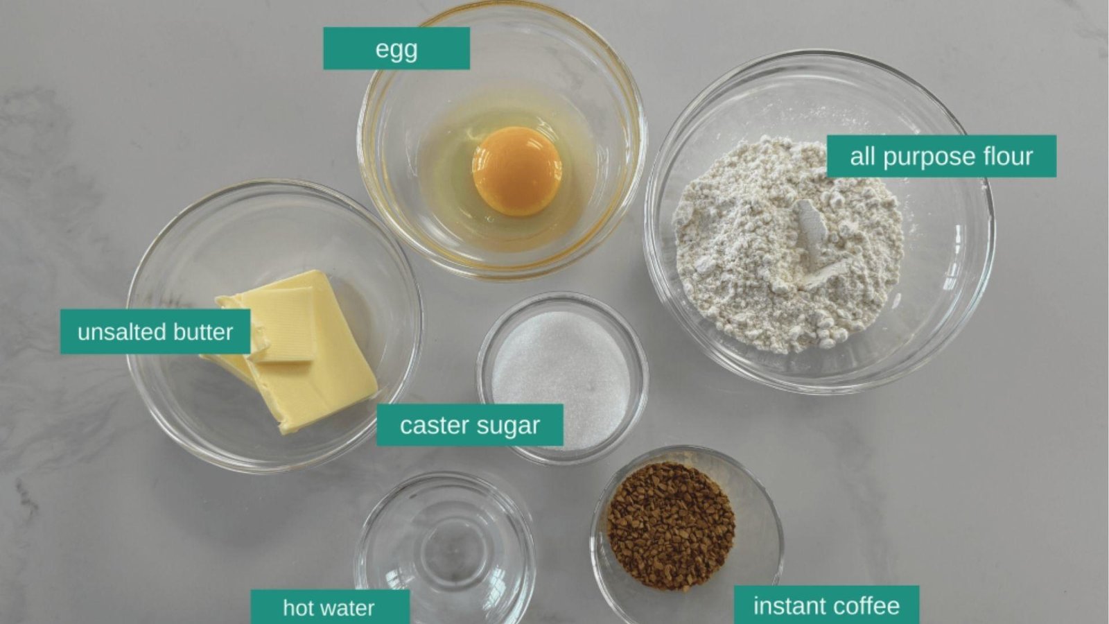 Labeled ingredients for coffee bread: egg, all purpose flour, unsalted butter, and caster sugar.