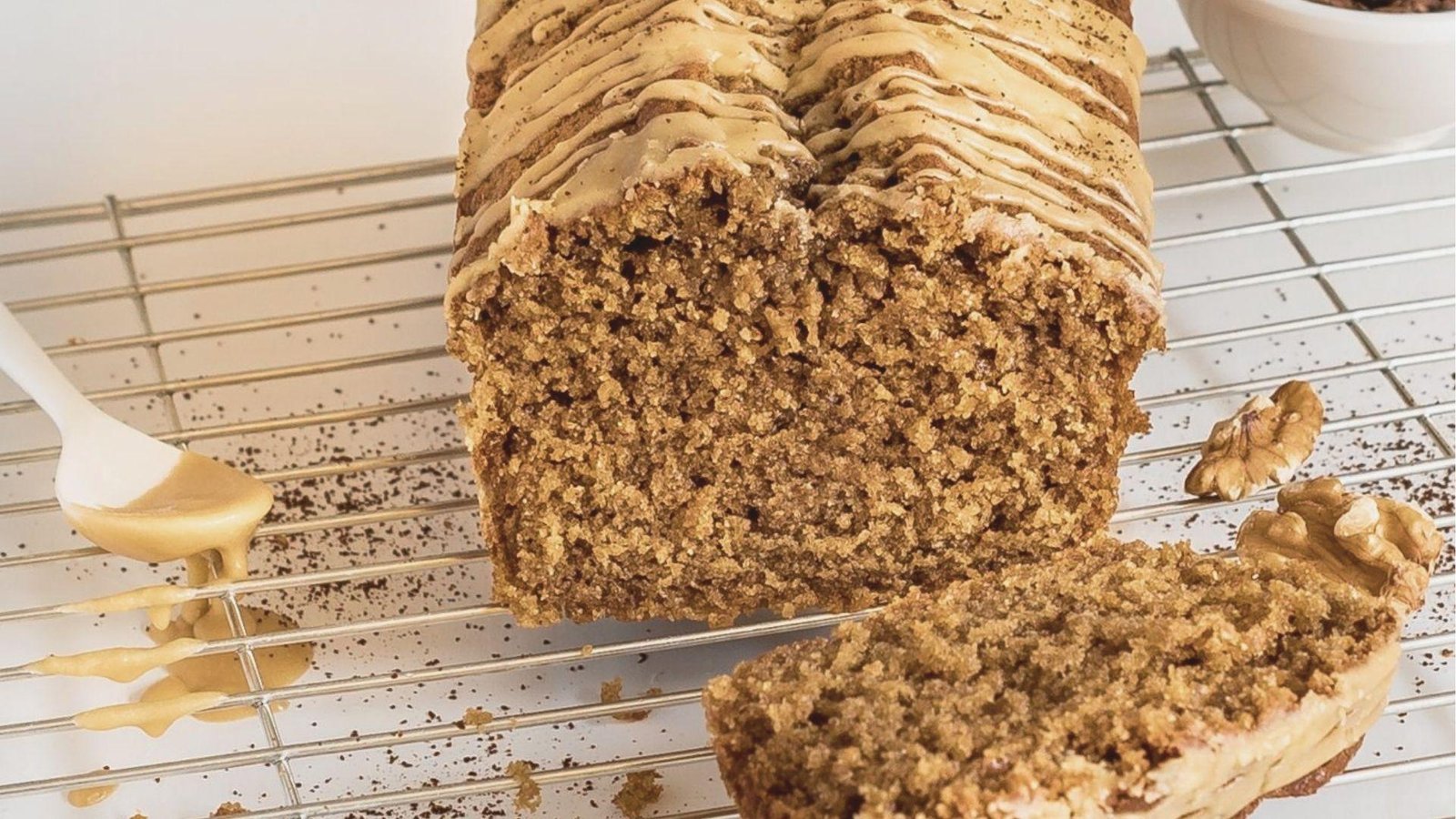 Freshly baked coffee bread loaf drizzled with coffee glaze on a wire rack.