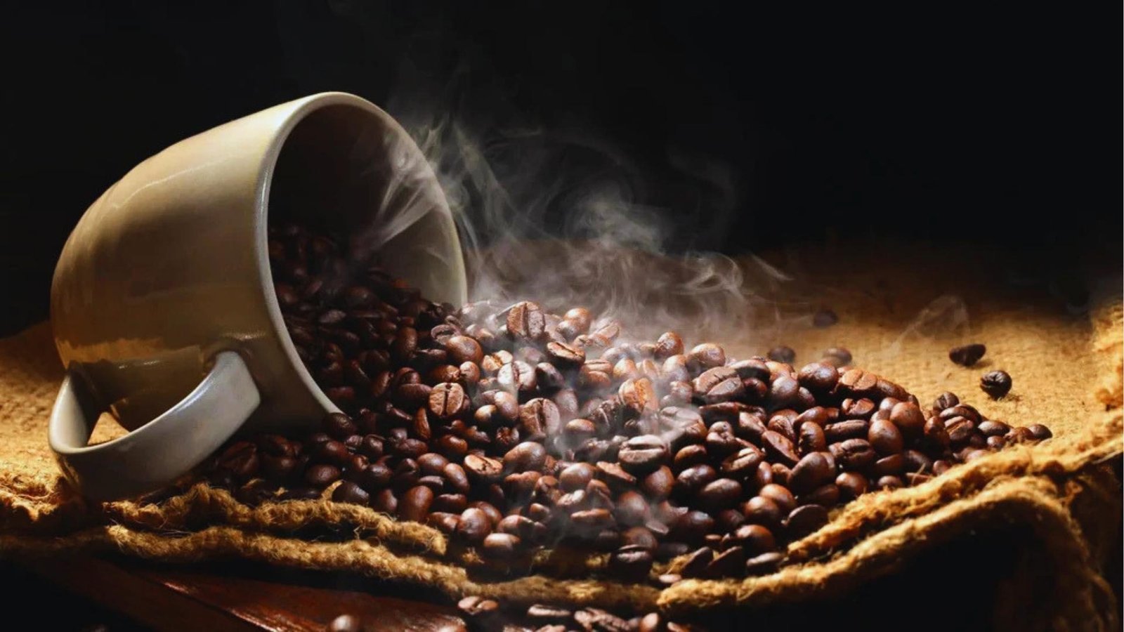 Steaming coffee beans spill from tipped white mug onto burlap sack, with warm light highlighting roasted beans and wisps.