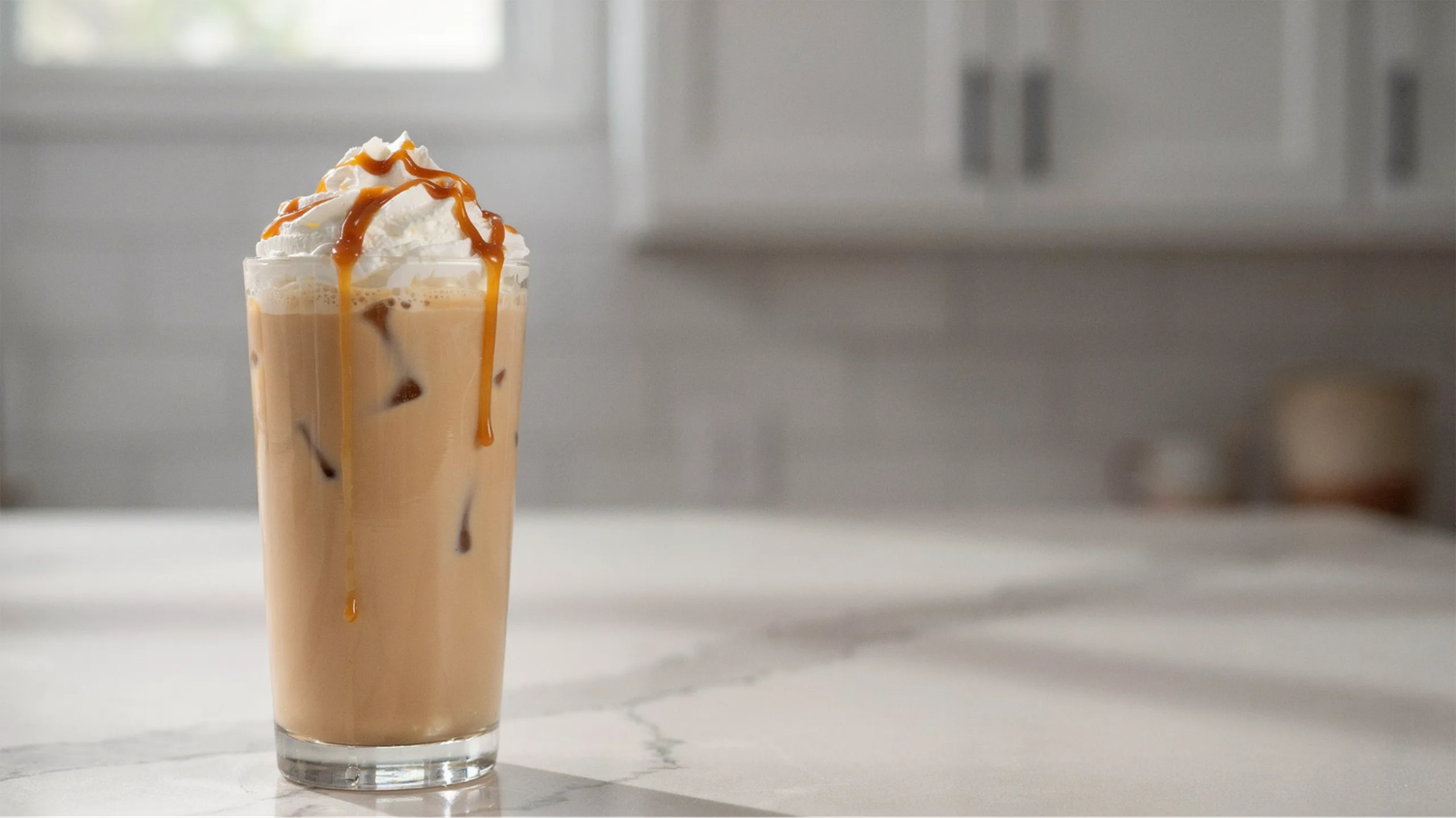 caramel blended coffee with whipped cream and smooth caramel drizzle showing thick creamy texture.
