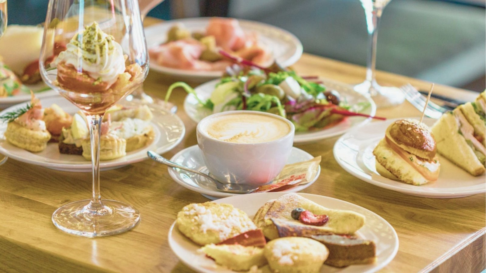 A table set with various plates of food and drinks, showcasing a colorful and appetizing spread for dining.